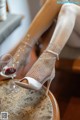 A woman sitting at a table with a glass of wine.