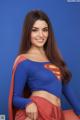 A woman in a superman costume posing for a picture.