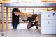 A woman in stockings and stockings is bending over a desk.