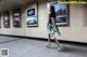 A woman in a dress is walking through a subway station.