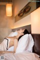 A woman laying on a bed in a hotel room.