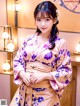 A woman in a kimono posing for a picture.