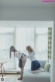 Two young women in school uniforms are sitting on a couch.