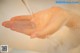 A person washing their hands with soap in a sink.